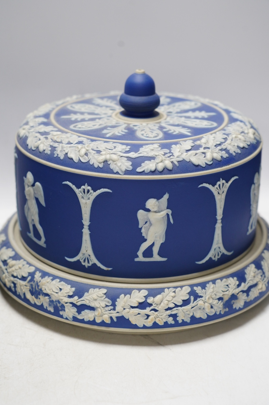 Two Wedgwood blue jasperware cheese dishes and covers, largest 29cm in diameter. Condition - good